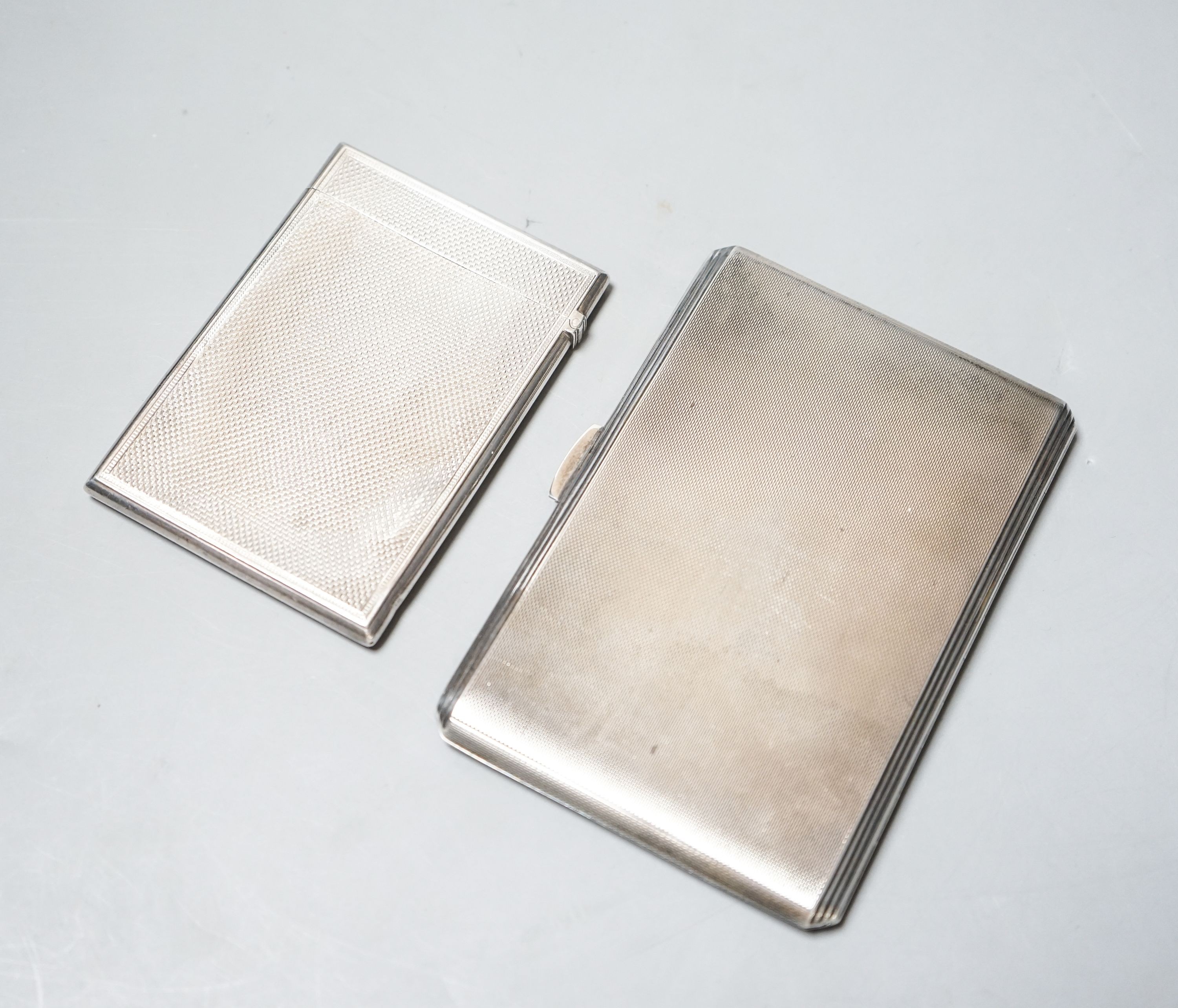 A Victorian engine turned silver card case, 95mm and a later silver cigarette case, gross 8.5oz.